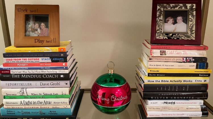 Books on a shelf with picture frames