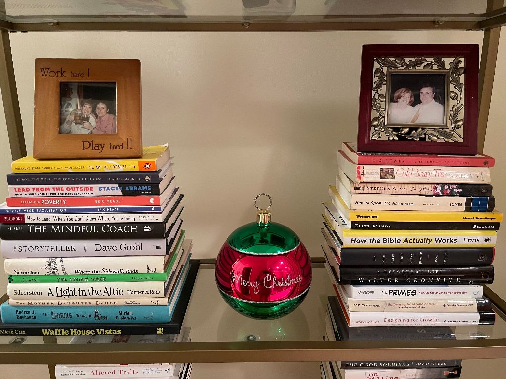 Books on a shelf with picture frames