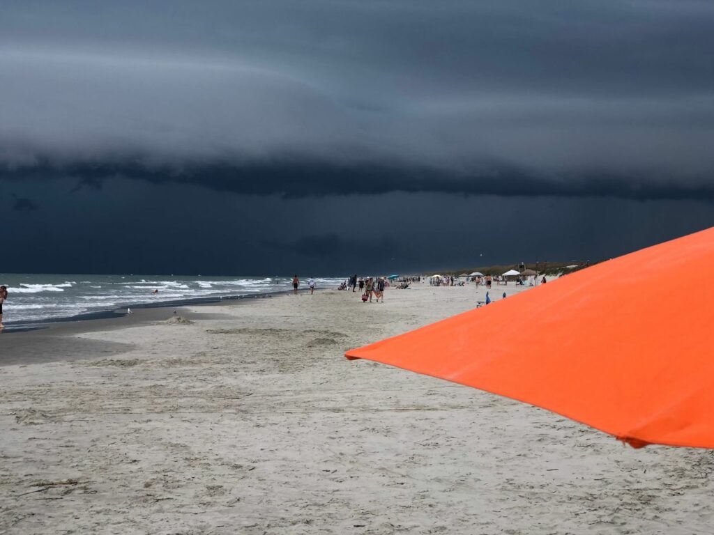 dark strom clouds and orange umbrella