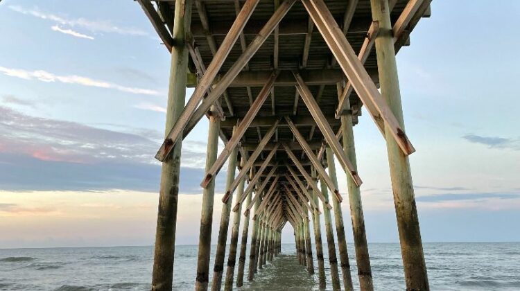 below a beach pier