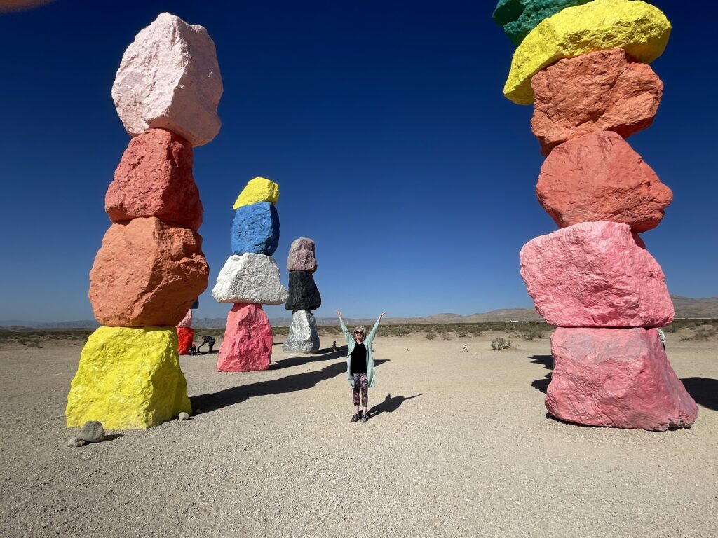 Emily stands at "7 Magic Mountains" art in Las Vegas