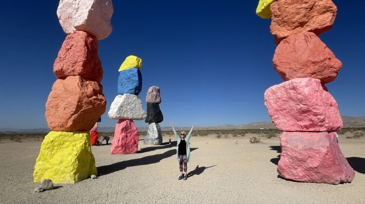 Emily stands at "7 Magic Mountains" art in Las Vegas
