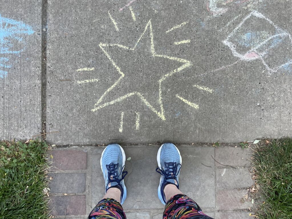 Feet on sidewalk next to start drawing