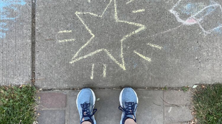 Feet on sidewalk next to start drawing
