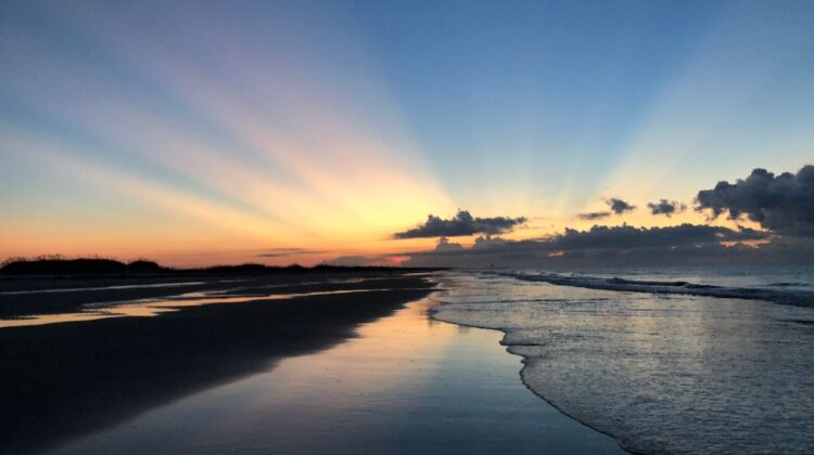 Sun's morning rays of light during sunrise at the beach