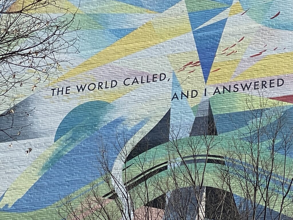"The world called, and I answered" painted on the wall of a building