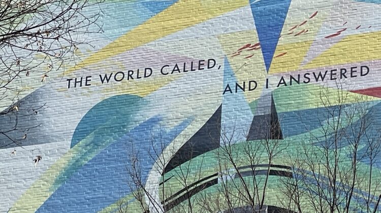 "The world called, and I answered" painted on the wall of a building